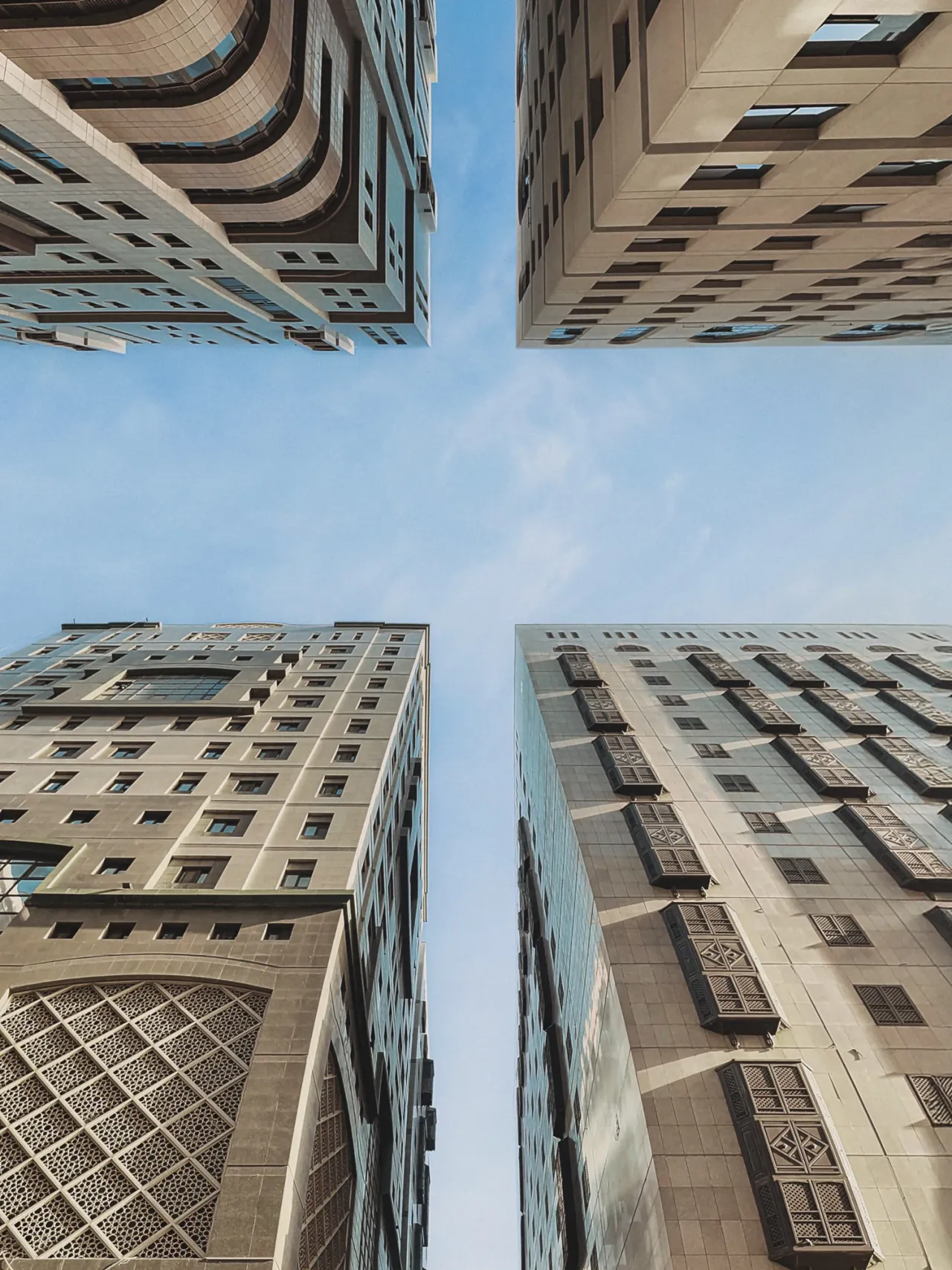 Looking upward between tall buildings