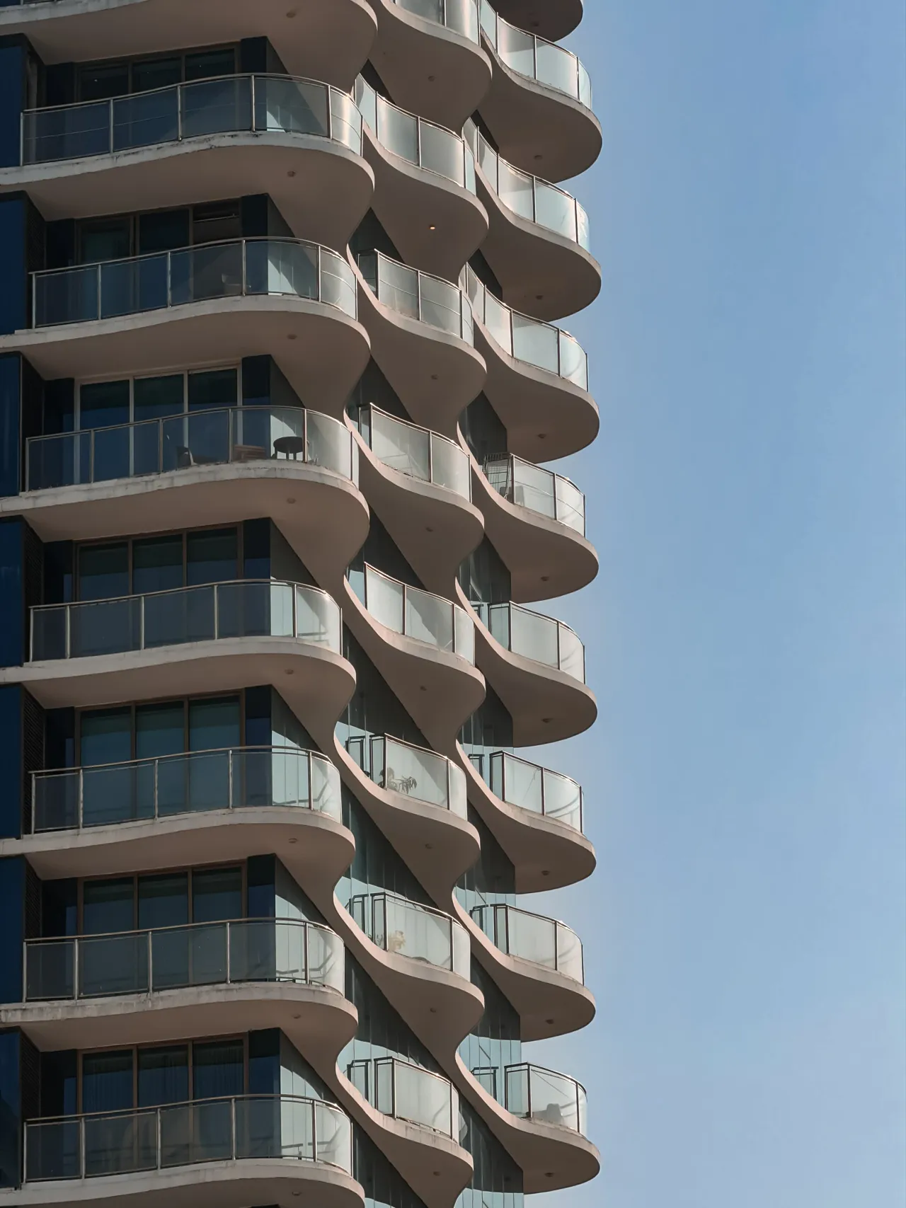 Curved balconies against a clear sky