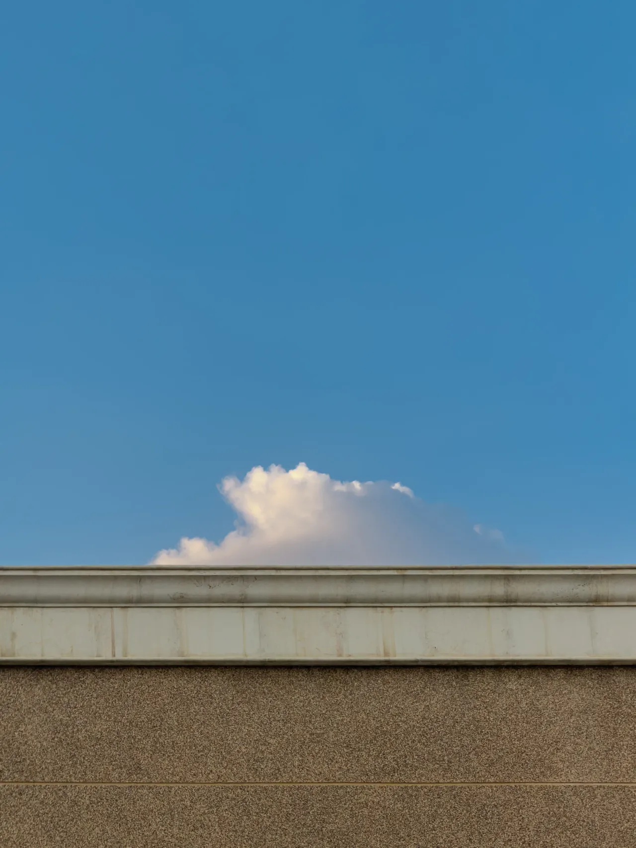 A cloud above a quiet wall