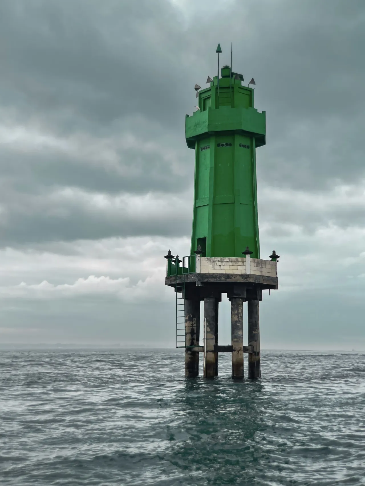 A green beacon above the sea