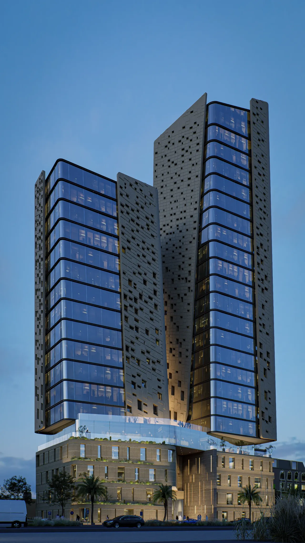 Current facade — evening view of the illuminated towers and podium